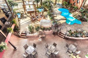 an overhead view of a patio with tables and a pool at Hotel Universel in Quebec City