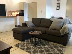 a living room with a couch and a table at San Juan Metro Host in San Juan