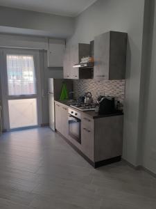 a kitchen with a sink and a stove in it at IL QUADRIFOGLIO in Rome