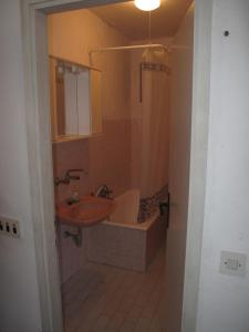 a bathroom with a sink and a shower and a tub at Apartments Žuvela in Korčula