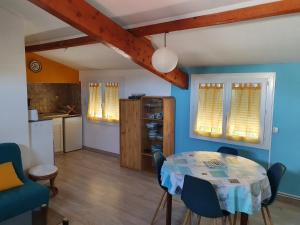 a kitchen and dining room with a table and chairs at Villa Dora in Frontignan