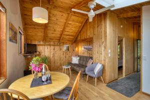 a living room with a table and a couch at Buena Vista Apartment in Marahau