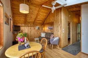 a living room with a table and chairs and a couch at Buena Vista Apartment in Marahau