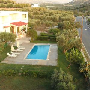 an aerial view of a villa with a swimming pool at Kassiani Studios in Plakias