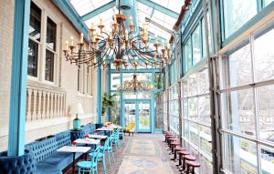 a room with tables and chairs and a chandelier at Hotel Havana in San Antonio