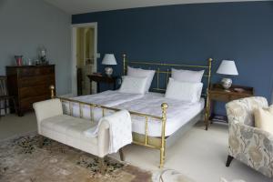A bed or beds in a room at The Empty Nest B & B