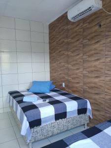 a bedroom with a bed with a blue pillow on it at HOTEL CIDADE EXPRESS 24H in Teresina
