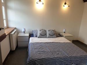 a bedroom with a bed with two pillows on it at Ty Keramor in Hôpital-Camfrout
