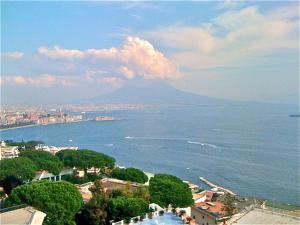 a view of the ocean with a mountain in the background at B&B Dipintodiblu' in Naples