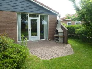 una porta d'ingresso di una casa con un cortile di mattoni di Ferienhaus Lisakowski a Warmenhuizen