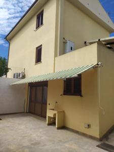a building with awning on the side of it at Oro&Mattia's House in Trapani