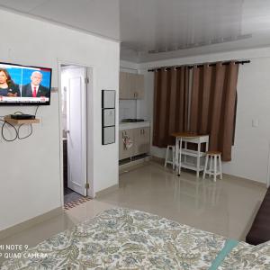 a living room with a flat screen tv on the wall at SWEET BREEZE in San Andrés