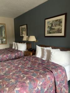 a hotel room with two beds and two lamps at Bancroft Inn & Suites in Bancroft