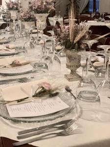 a table with plates and napkins and silverware on it at Sui Passi di Francesco in Valfabbrica