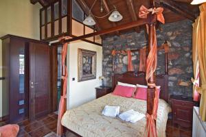 a bedroom with a canopy bed with pink pillows at Luxurious Residence at the Village Square in Palaios Agios Athanasios