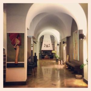 a hallway in a building with an arch way at Hotel Principe Di Villafranca in Palermo