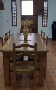 a wooden table with a vase on top of it at Cuevas Lourdes in Benamaurel