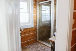 a bathroom with a shower with a glass door at Kolíska pokoja in Osturňa +25 photos