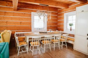 a dining room with a table and chairs at Kolíska pokoja in Osturňa