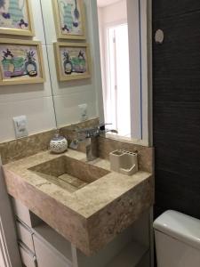 ein Bad mit einem Waschbecken und einem Spiegel in der Unterkunft NORTH PARADISE 309- Duplex in Florianópolis