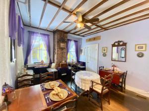 a living room with a table and chairs and a ceiling at Penny Farthing Inn in Saint Augustine