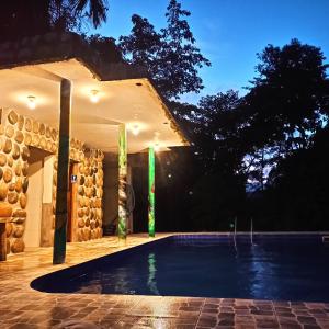 a swimming pool in a house at night at Rio Napo Lodge in Puerto Misahuallí