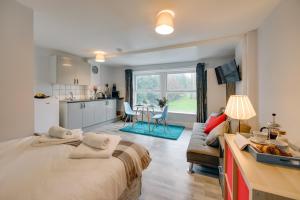 a bedroom with a large bed and a kitchen at Grey Stone Studio Apartments in Halifax