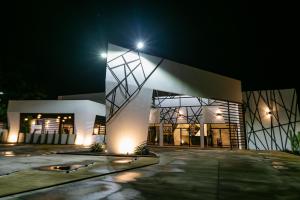 a large building with lights on it at night at D' LA TORRE HOTEL in Managua