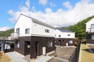 a house with white and brown at Villas Asama no Iori in Fujiyoshida