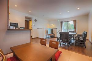 a living room with a table and chairs at Villas Asama no Iori in Fujiyoshida
