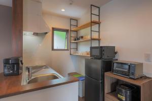 a small kitchen with a sink and a refrigerator at Villas Asama no Iori in Fujiyoshida