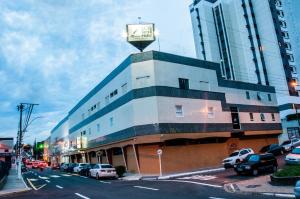 a building with a water tower on top of it at Alves Hotel in Marília