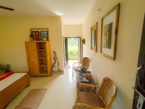 a bedroom with a bed and chairs and a table at Nature Care Village- Rajaji National Park in Rishīkesh