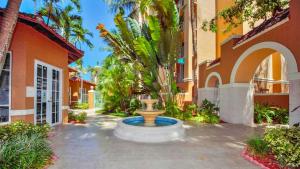 a courtyard with a fountain in front of a building at Three-Bedroom Apartment at The Yacht Club Aventura in Aventura