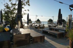 a patio with tables and chairs and umbrellas at Appartement Lotte in Kiel