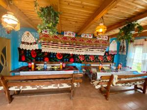 a dining room with benches and christmas decorations at Floare de Maramures 2 in Sighetu Marmaţiei