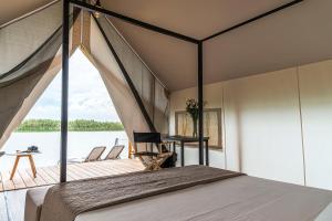 a bedroom on a boat with a bed and a desk at Nabi Resort Glamping & SPA in Castel Volturno +37 photos