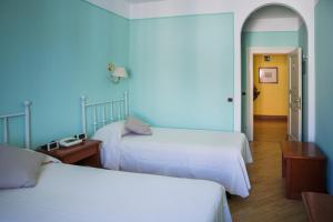 En eller flere senge i et værelse på Hotel San Genesio