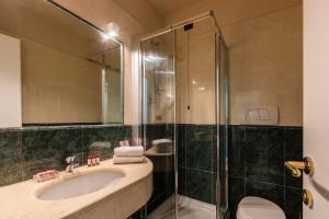 a bathroom with a sink and a shower at Hotel Coppede' in Rome +33 photos