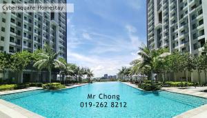 a swimming pool in the middle of two buildings at Cybersqaure Studio Suites with Netfilx @10 min walking distance to McD in Cyberjaya