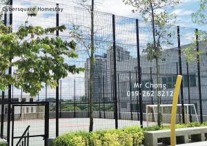 a fence with a sign in front of a building at Cybersqaure Studio Suites with Netfilx @10 min walking distance to McD in Cyberjaya