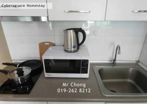 a microwave sitting on top of a kitchen counter at Cybersqaure Studio Suites with Netfilx @10 min walking distance to McD in Cyberjaya