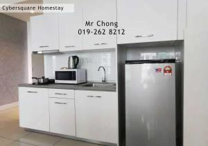 a kitchen with a refrigerator and a microwave at Cybersqaure Studio Suites with Netfilx @10 min walking distance to McD in Cyberjaya