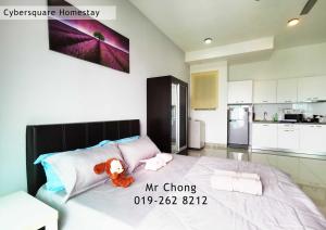 a bedroom with a bed with a teddy bear on it at Cybersqaure Studio Suites with Netfilx @10 min walking distance to McD in Cyberjaya