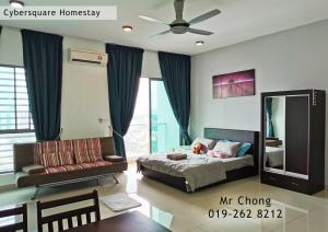 a bedroom with a bed and a couch at Cybersqaure Studio Suites with Netfilx @10 min walking distance to McD in Cyberjaya
