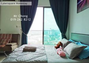 a bed with a teddy bear on it in a room with a window at Cybersqaure Studio Suites with Netfilx @10 min walking distance to McD in Cyberjaya +25 photos