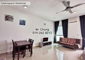 a living room with a table and a couch at Cybersqaure Studio Suites with Netfilx @10 min walking distance to McD in Cyberjaya