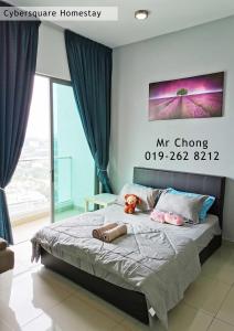 a bed with two stuffed animals sitting on it in a bedroom at Cybersqaure Studio Suites with Netfilx @10 min walking distance to McD in Cyberjaya