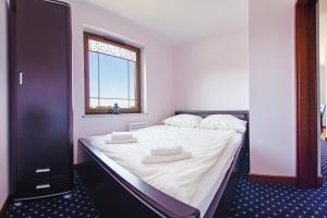 Postel nebo postele na pokoji v ubytování Continental, Sun & Snow