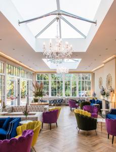 a large room with purple chairs and a chandelier at Cork's Vienna Woods Hotel & Villas in Cork